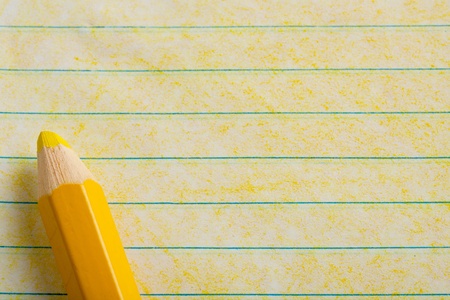 Yellow color pencil with coloring on a piece of paperの写真素材