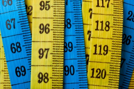 Closeup of the numbers on colorful measuring tapesの写真素材