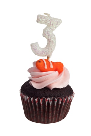 Mini cupcake with birthday candle for three year old isolated on white backgroundの写真素材