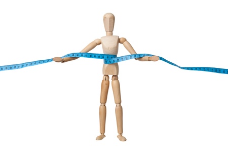 Wooden mannequin holding a measuring tape isolated on white backgroundの写真素材