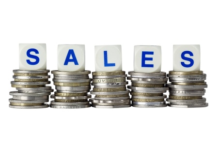 Stacks of coins with the word SALES isolated on white backgroundの写真素材