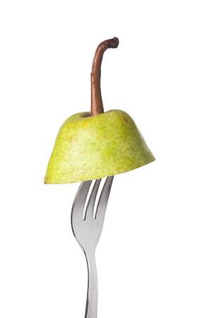 Section of a pear held by a fork isolated on white backgroundの写真素材