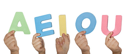 Hands holding the vowel letters of the English alphabetの写真素材