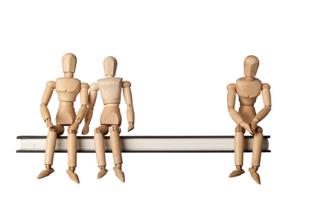 Relationship between three people depicted by three figurines isolated on white background