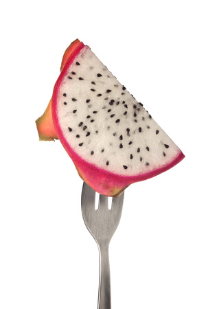 Slice of dragonfruit on a fork isolated on white backgroundの写真素材