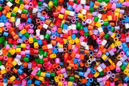 Lots of colorful fusible plastic beads used for arts and craftの写真素材