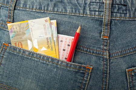 Swiss money and lottery betting slip in back pocketの写真素材