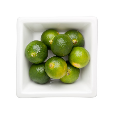 Calamondin fruits in a square bowl isolated on white backgroundの写真素材