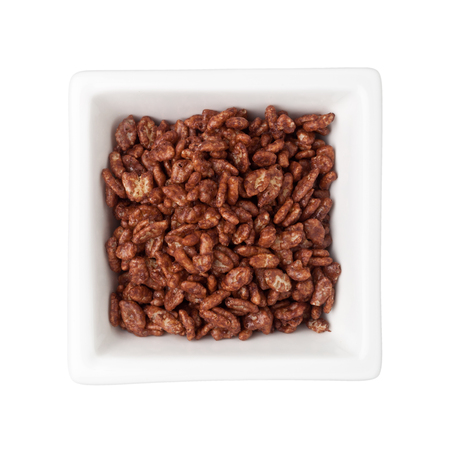 Chocolate flavored breakfast cereal in a square bowl isolated on white backgroundの写真素材