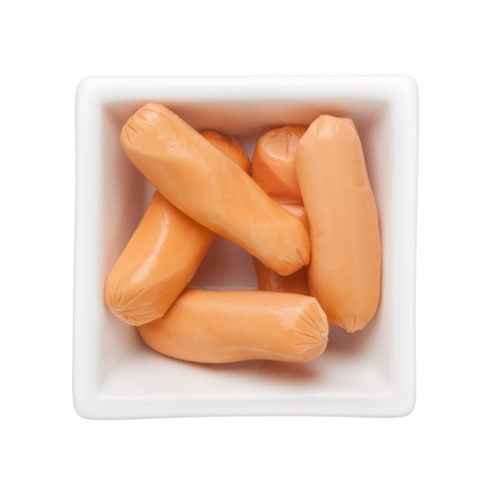 Chicken cocktail sausages in a square bowl isolated on white backgroundの写真素材