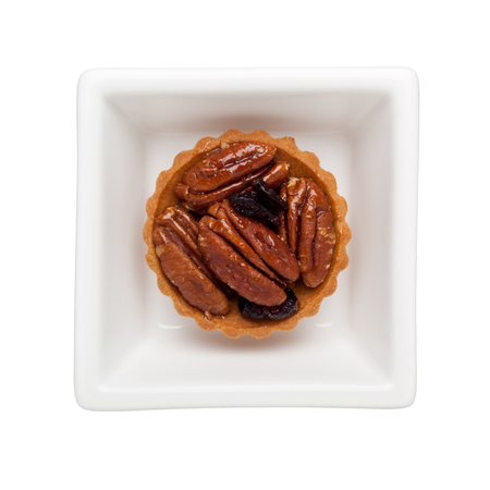 Walnut tart in a square bowl isolated on white background
の写真素材