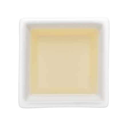 Canola oil in a square bowl isolated on white backgroundの写真素材