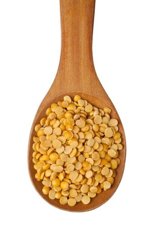 Toor dal in a wooden spoon isolated on white backgroundの写真素材