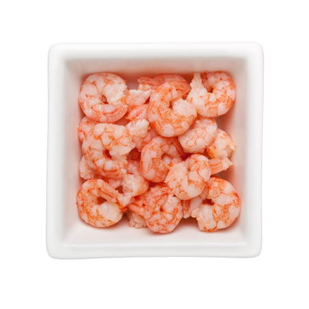Pile of small cooked shrimps in a square bowl isolated on white backgroundの写真素材