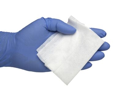 Gloved hand holding a piece of antibacterial cleansing wipe isolated on white background;の写真素材