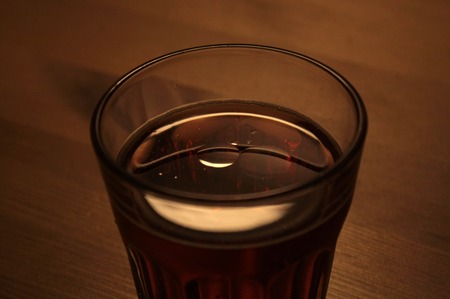   Atmospheric image of a drink with a drop of oil, creating amazing reflections.の写真素材