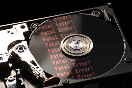   Hard disk on a black background, reflecting error message.の写真素材