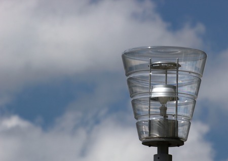   Modern street lamp in front of blue sky with clouds.の写真素材