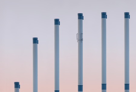   Smoke pipes in ascending row showing saturation curve.の写真素材