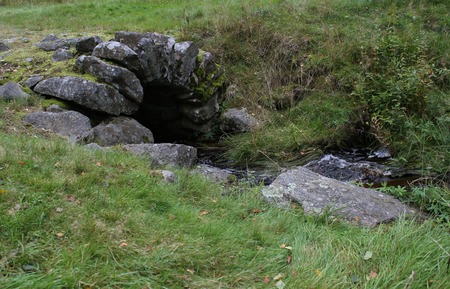 Water stream with old stone tunnel.