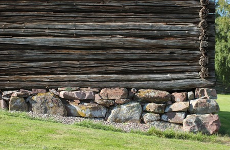 Bottom of a log hut built on a slope in Sweden.の写真素材