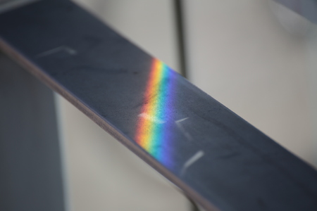 Iridescent reflection on a metal rail.の写真素材