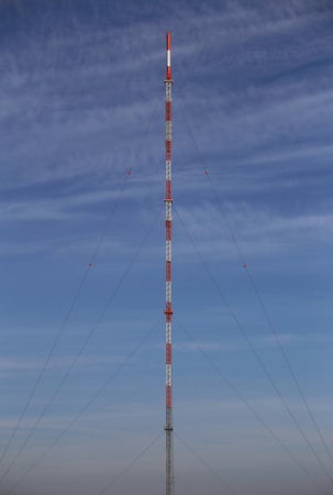 Symmetric view of red and white radio tower