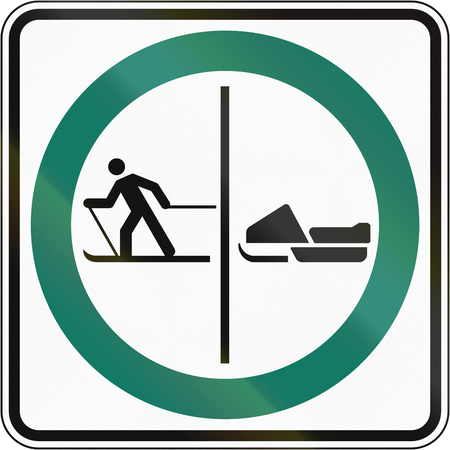 Regulatory road sign in Quebec, Canada - Skier and snowmobile lane.の写真素材