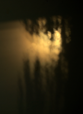 Abstract light effects produced by sunlight and shadow.