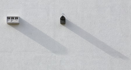 Different nest boxes installed on a house wall.の写真素材