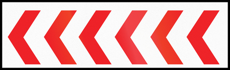 Road sign used in Cyprus - Chevron at the side of the road.の写真素材