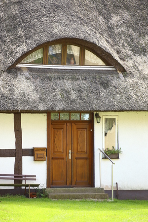 Entrance of reed roofed house, listed as monument in Kroeslin, Germany.のeditorial素材