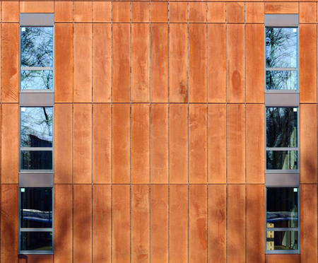 Rusty steel panels and windows on a modern building.