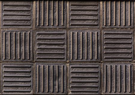 Dark vitrified clay panels with alternating directions.
