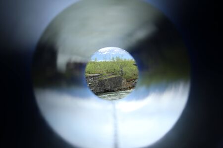 Unusual shot through a colored tube, a cliff at the stream Abiskojakka can be seen.の写真素材