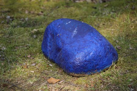 Conceptual shot of a stone painted in blue.の写真素材