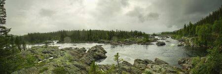 Rainy weather over rapids at the stream Kultsjoan in Vasterbotten, Sweden.