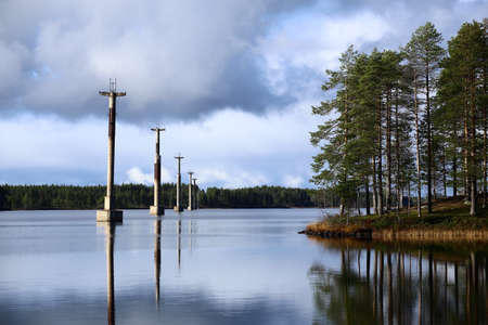 Row of concrete pillars on lake Menstrask, part of the old material ropeway Linbanan Kristineberg-Boliden.の写真素材