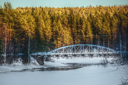 Small arch bridge over river in Swedish Lapland.の写真素材