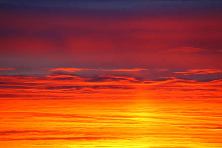 Layered cloudscape in orange and pink color.の写真素材