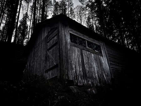 Dark high contrast shot of an old wooden shed.の写真素材