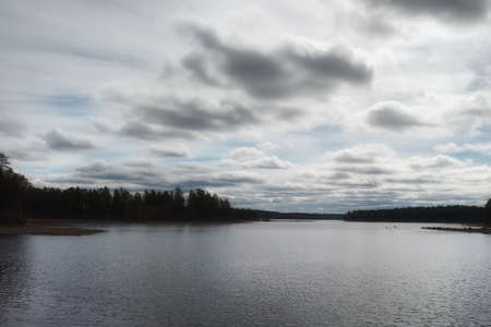 High contrast shot of Swedish lake and clouds.の写真素材