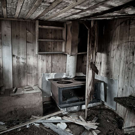 Interior of an abandoned hut with ruined stove.の写真素材