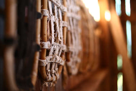 Row of traditional snow shoes hanging on a wall in an old barn.の写真素材