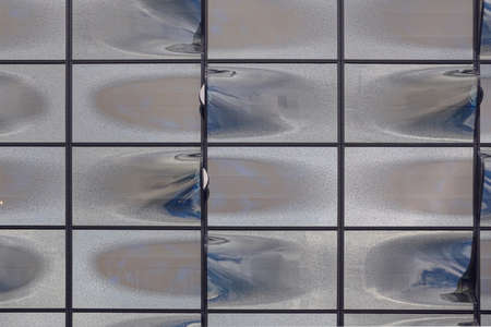 Curved glass facade of a modern building.の写真素材