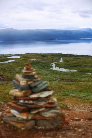 Rock cairn in front of lapland landscape.の写真素材