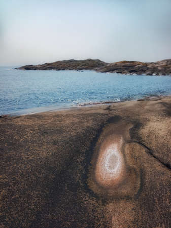 Dry puddle at a rocky coast, accumulating salt.の写真素材