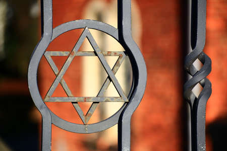 Star of david at the gate of a jewish cemetery.