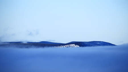 Dense fog and clouds in front of mountains.の写真素材