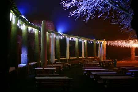 Empty outdoor restaurant with christmas decoration in the night.の写真素材